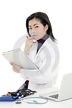 Asian woman Doctor or Nurse working at a desk holding a medical pad