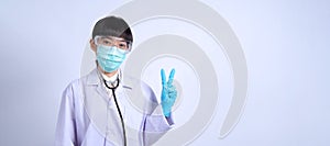 Asian woman doctor pointing finger out to copy space