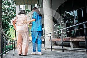 Asian woman doctor shook hands, encouraged and supported elderly woman patien