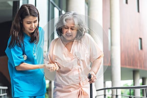 Asian woman doctor shook hands, encouraged and supported elderly woman patient