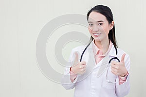 Asian woman doctor shows hand as thump up who wears medical clothing