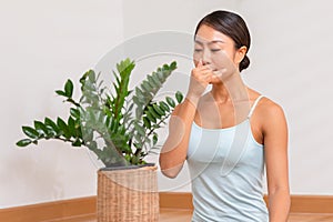 Asian woman doing breathing exercise before practice yoga.Healthy female inhaling and exhaling to deep breath exercise for control photo