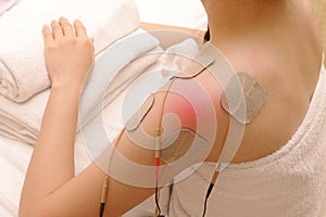 Asian woman is doing massage of electrical -stimulation ( TENs )