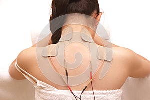 Asian woman is doing massage of electrical -stimulation ( TENs ) photo