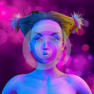 Asian woman doing a open eyes kiss in colorful bright neon lights posing in studio