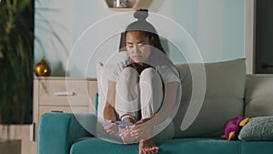 Asian woman doing pedicure and watching TV