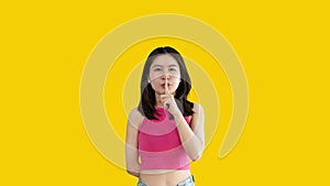 Asian woman doing silent gesture with finger