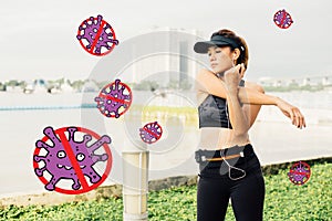 Asian woman doing stretching exercises outdoors along city sidewalk