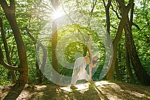 Asian woman doing yoga in the park