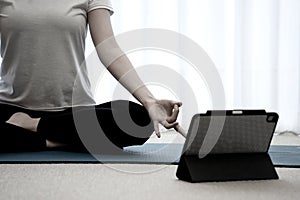 Asian woman doing yoga poses on a yoga mat