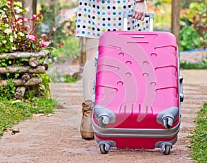 Asian woman dragging a suitcase