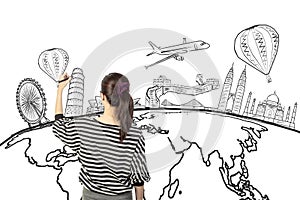 Asian woman drawing or writing dream travel around the world