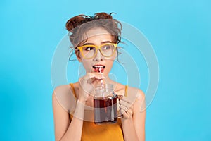 Asian woman drinking carbonated drink through a straw