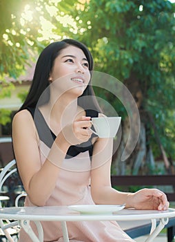 Asian woman drinking coffee.