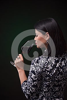 Asian woman drinking red wine