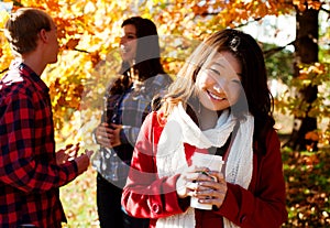 Asian woman drinking a warm drink