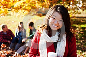 Asian woman drinking a warm drink