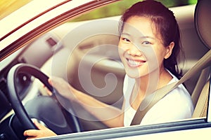 Asian woman driver driving a car