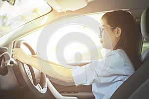 Asian woman driving car with feeling happy