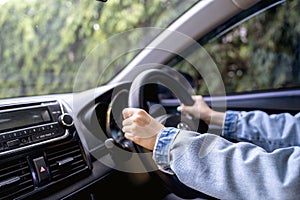Asian woman while driving the car in the morning on road, Transportation and vehicle concept