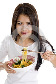 Asian woman eating with chop sticks