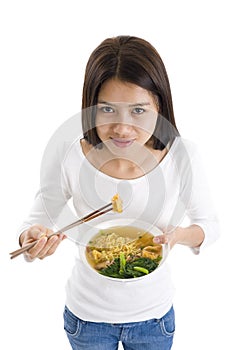 Asian woman eating with chop sticks