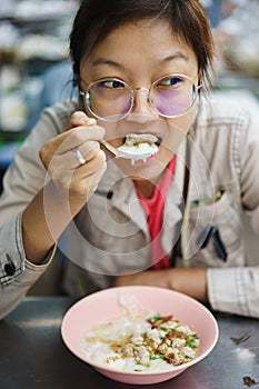Asian woman eating crepe congree photo