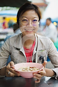 Asian woman eating crepe congree congree photo