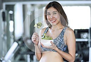 Asian woman eating healthy salad. diet health lifestyle concept