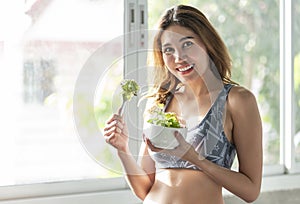 Asian woman eating healthy salad. diet health lifestyle concept