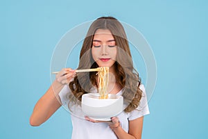 Asian woman eating hot quick instant noodles