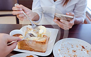 Asian woman are eating ice ream and delicious bread.Focus on for