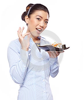 Asian woman eating sushi. Shallow depth of field, focu