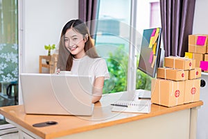 Asian woman enjoy herself while using laptops and internet in office. Business and marketing and part time concept. On line