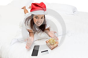 Asian woman enjoy shopping online for Christmas with computer la