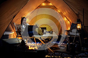 Asian woman enjoy in they tent in camping trip on night time with many star on the sky