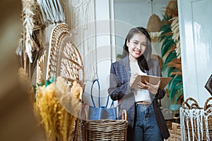 Asian woman entrepreneurs take notes on a handmade flower background