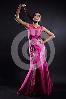 Asian woman in evening long ball dress