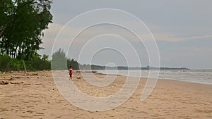 Asian woman exercise her dog at beach