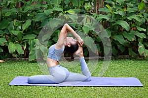 Asian woman exercising in the park Do yoga and meditate