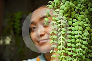 Asian woman with exotic dischidia houseplants photo