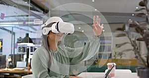 Asian woman explores virtual reality in a modern office setting