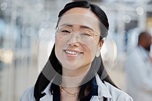 Asian woman, face and happy doctor in hospital for healthcare, wellness and glasses. Medical professional, portrait and