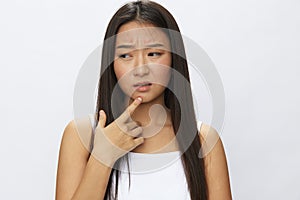 Asian woman facial skin problems, acne and inflammation, red rashes and allergies, chicken pox, sadness from rashes