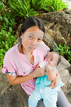 Asian woman feeding her baby top vertical