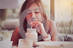 Asian woman feeling good while drink coffee