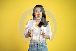 asian woman feeling shocked and suprised over isolated background