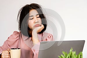 Asian woman Feeling tired or lacking energy after waking up and not feeling refreshed to start the day at the photo