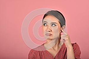 Asian woman feeling upset and frustrated, Girl rolling eyes with boredom and annoy about gossip. photo