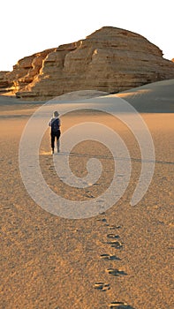 Asian woman female tourist backpacker walking in desert